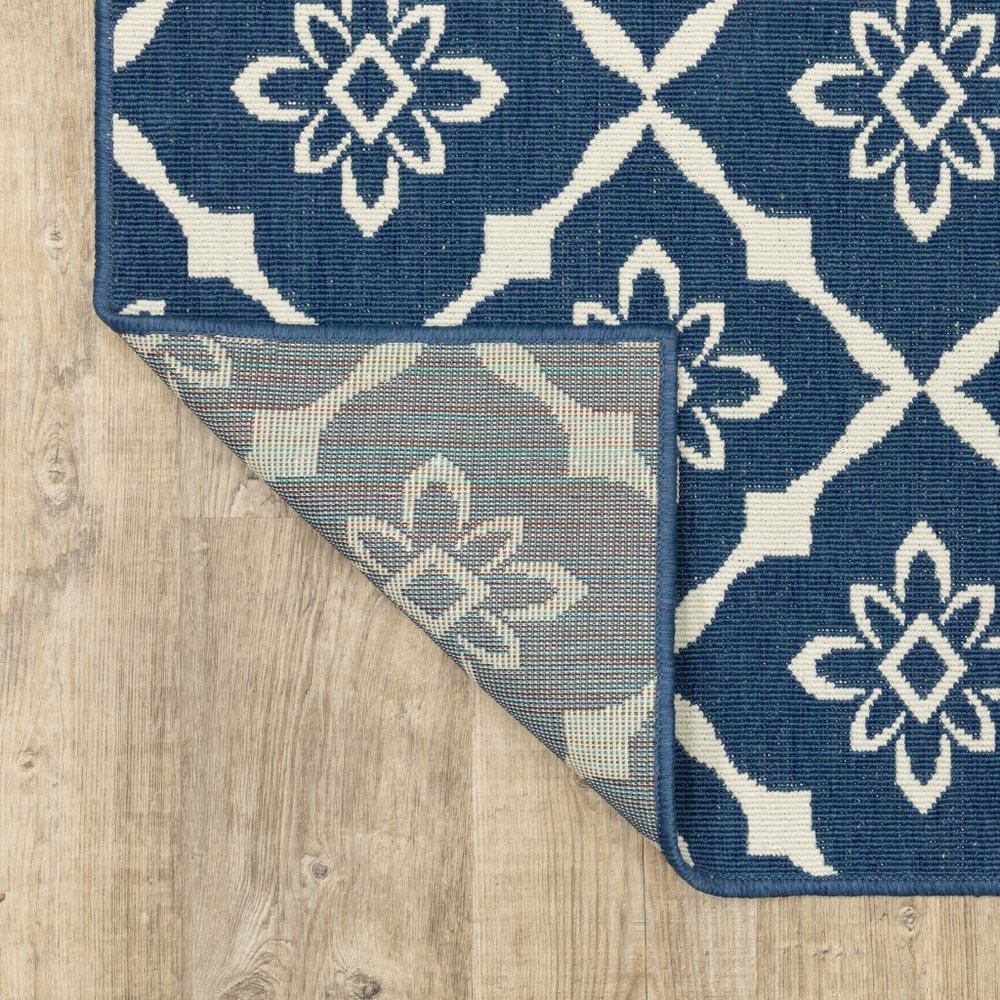 9' X 13' Blue and Ivory Floral Stain Resistant Indoor Outdoor Area Rug in a home interior
