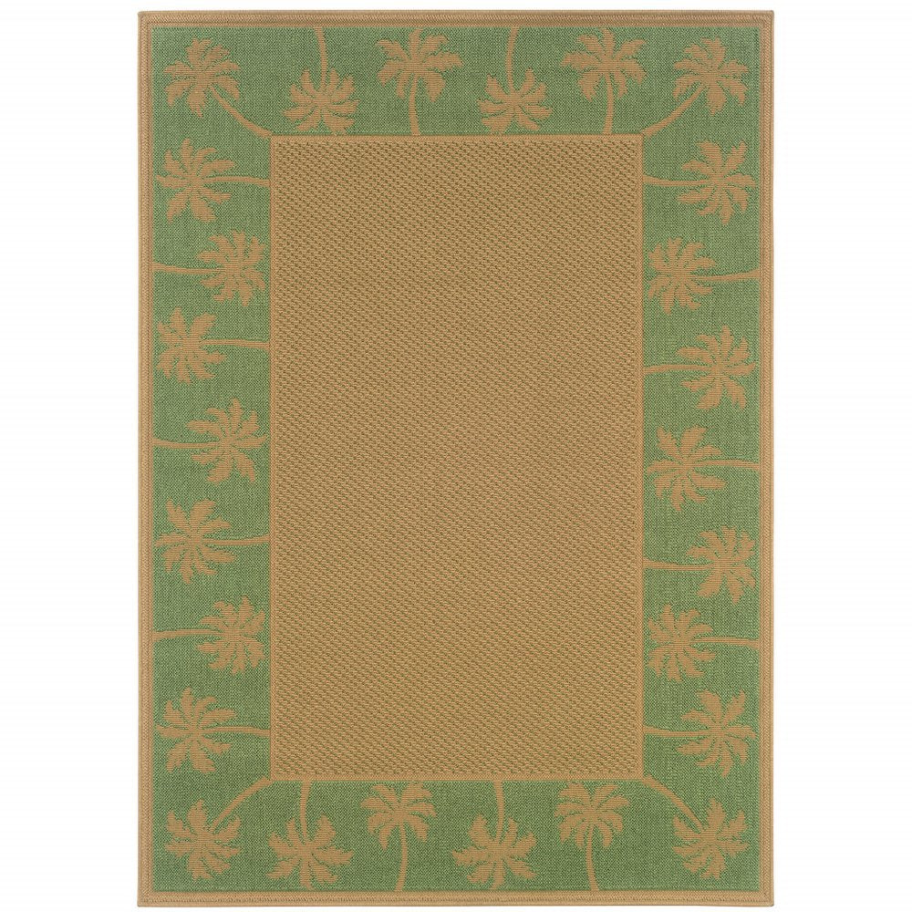 Rectangular beige indoor outdoor area rug with a green border featuring a palm tree pattern.