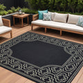 9' X 13' Black and Ivory Stain Resistant Indoor Outdoor Area Rug