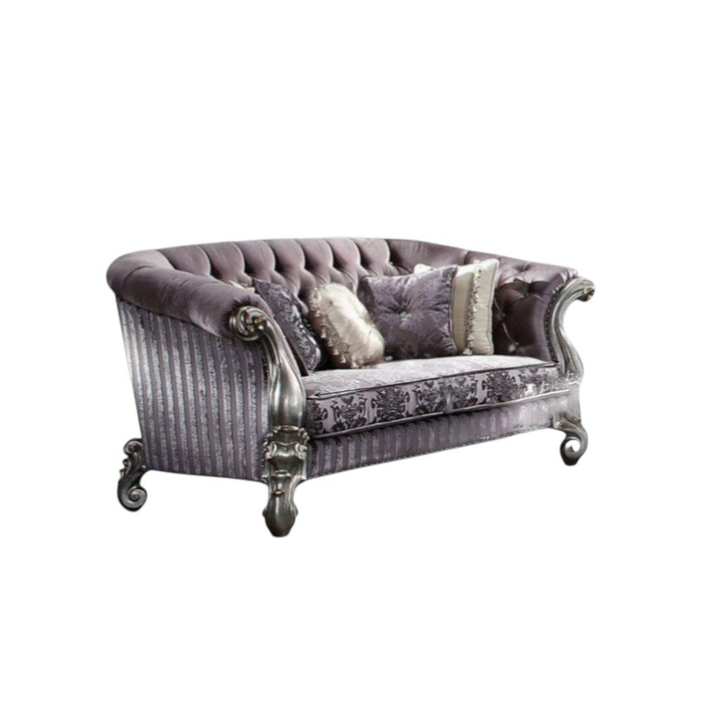 Purple and platinum velvet loveseat with ornate silver legs and decorative toss pillows on a white background.