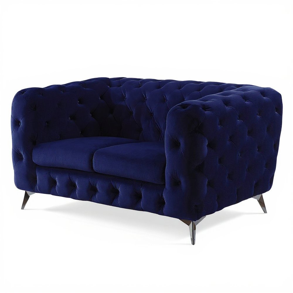 A blue velvet loveseat with tufted detailing and silver legs on a white background.