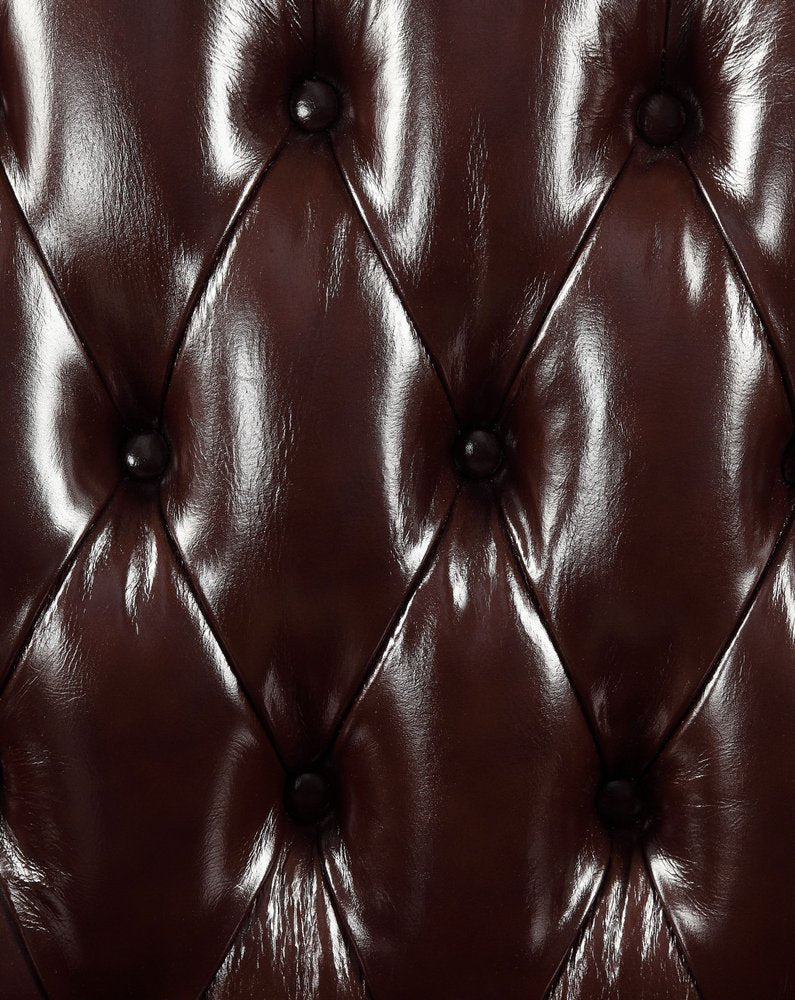 50" Espresso Faux Leather Tufted Wingback Chair And Toss Pillow close-up highlighting the black faux leather surface.