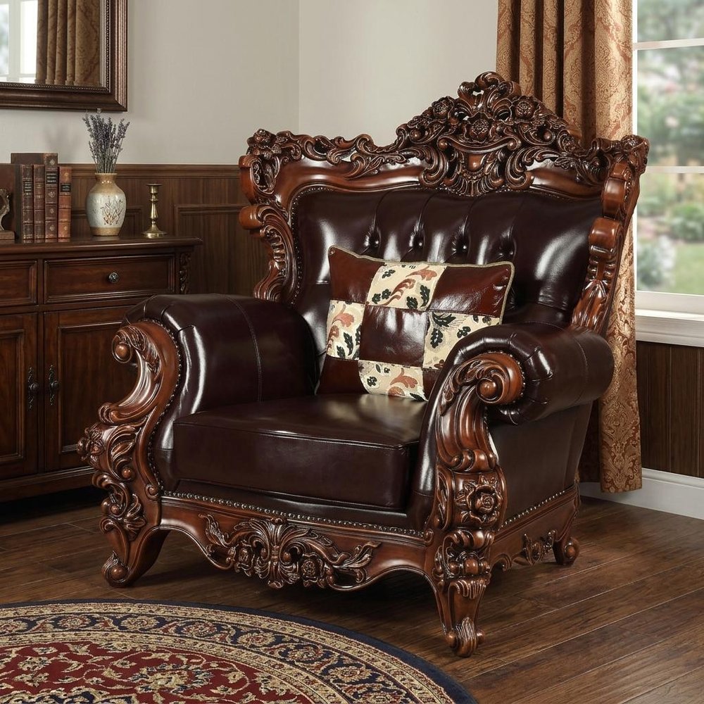 50" Espresso Faux Leather Tufted Wingback Chair And Toss Pillow styled in a furnished interior on a dark wood floor against a tan wall in dark brown faux leather.