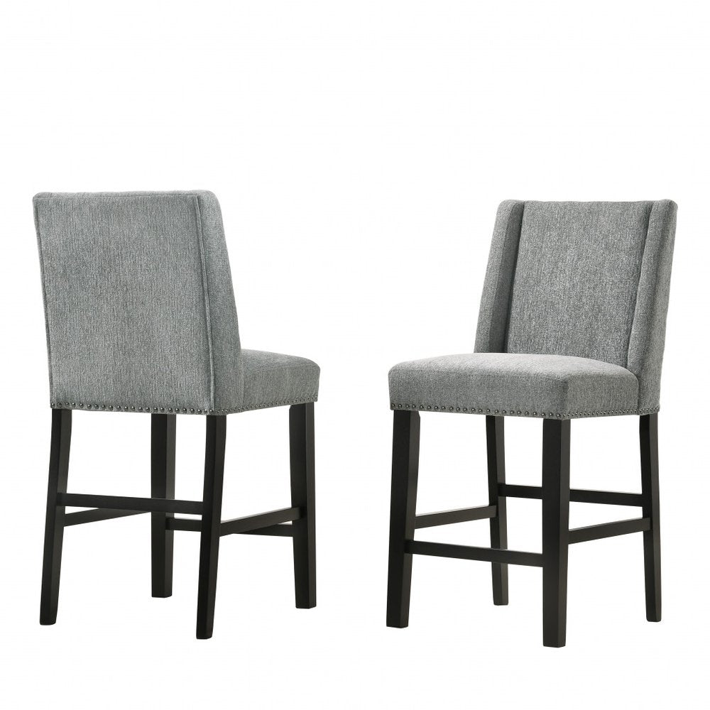 Two charcoal upholstered solid wood bar chairs with espresso legs on a white background.