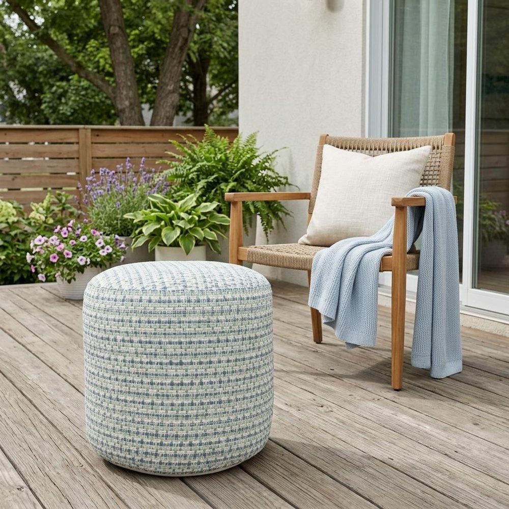 20" Blue Polyester Round Geometric Indoor Outdoor Pouf Ottoman shown outdoors on a patio with greenery.