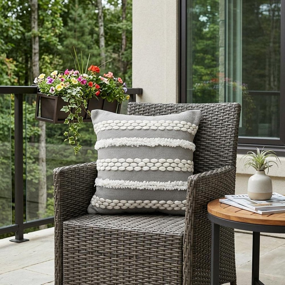 20" Gray and White Geometric Indoor Outdoor Throw Pillow With Texture shown outdoors on a patio with greenery.
