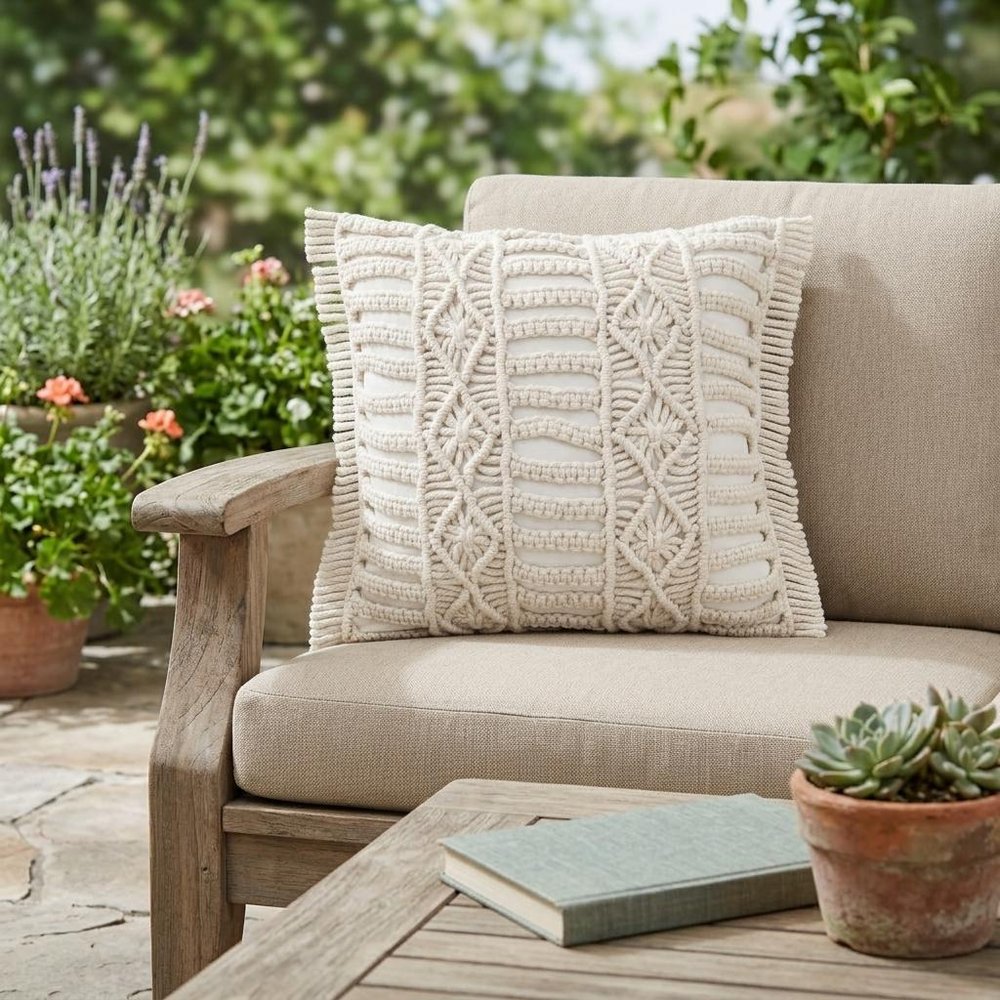 24" X 24" White Zippered Tropical Indoor Outdoor Throw Pillow shown outdoors on a patio with greenery.
