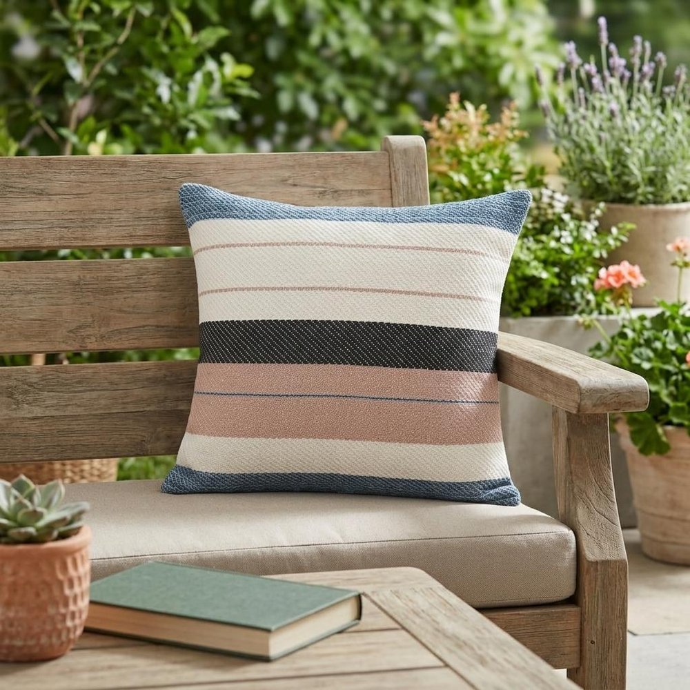24" X 24" White Zippered Striped Indoor Outdoor Throw Pillow shown outdoors on a patio with greenery.