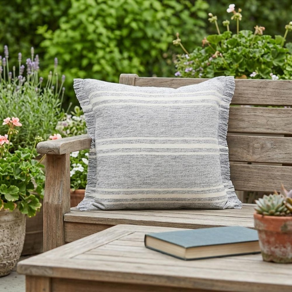 24" X 24" Gray Zippered Geometric Indoor Outdoor Throw Pillow shown outdoors on a patio with greenery.