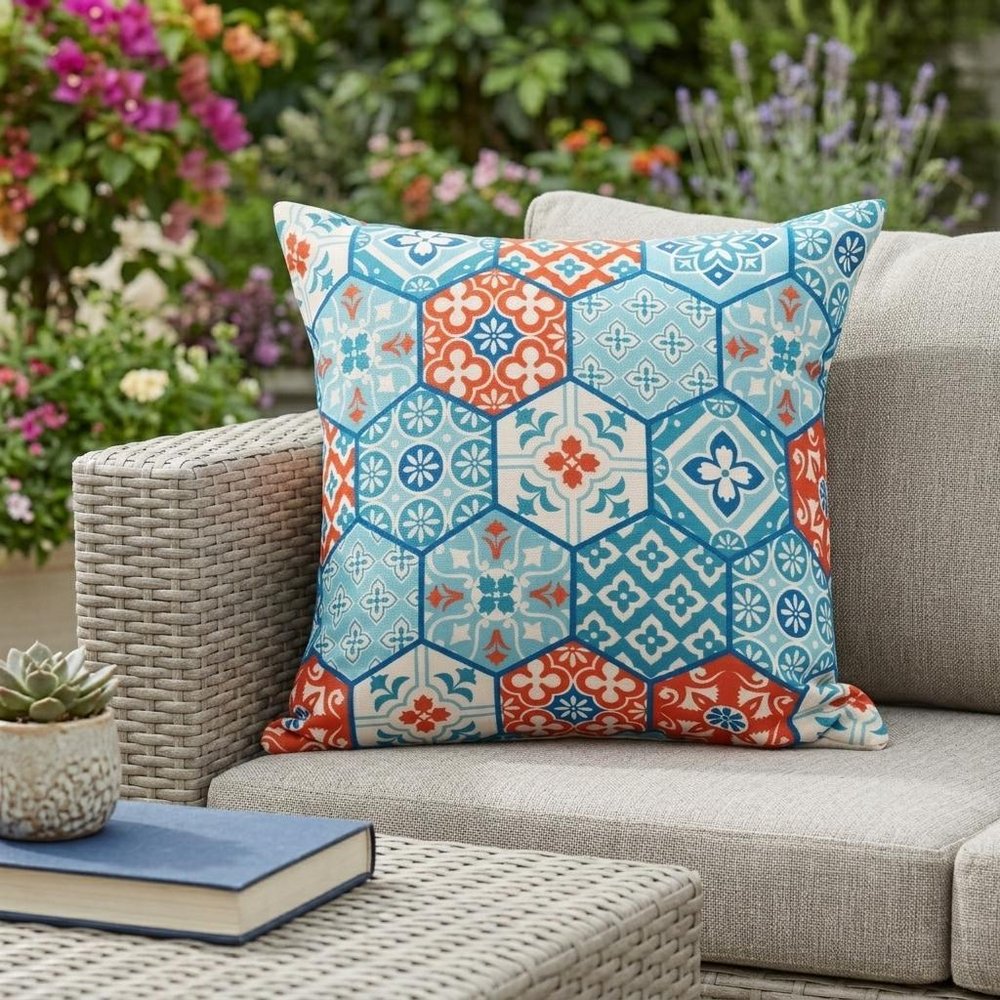 20" X 20" Blue Zippered Patchwork Indoor Outdoor Throw Pillow shown outdoors on a tiled patio with greenery.
