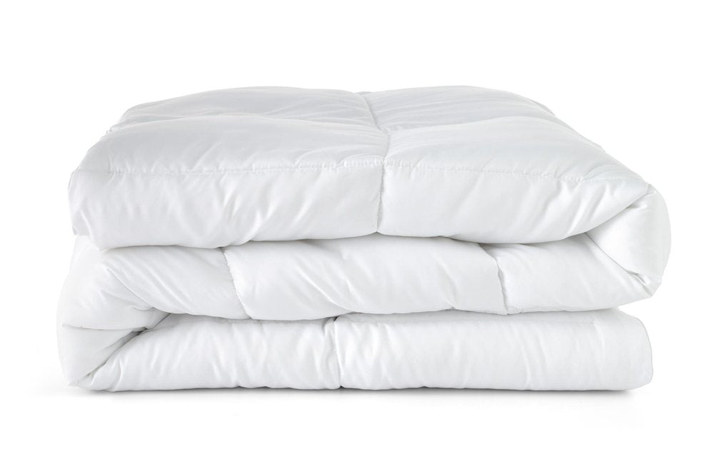 A white king-size down alternative comforter folded on a white background.