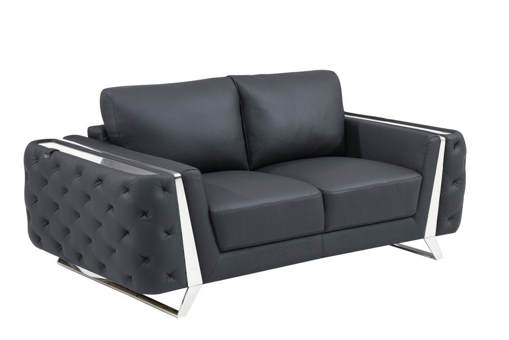 Dark gray genuine leather loveseat with tufted sides and silver metal accents on a white background.