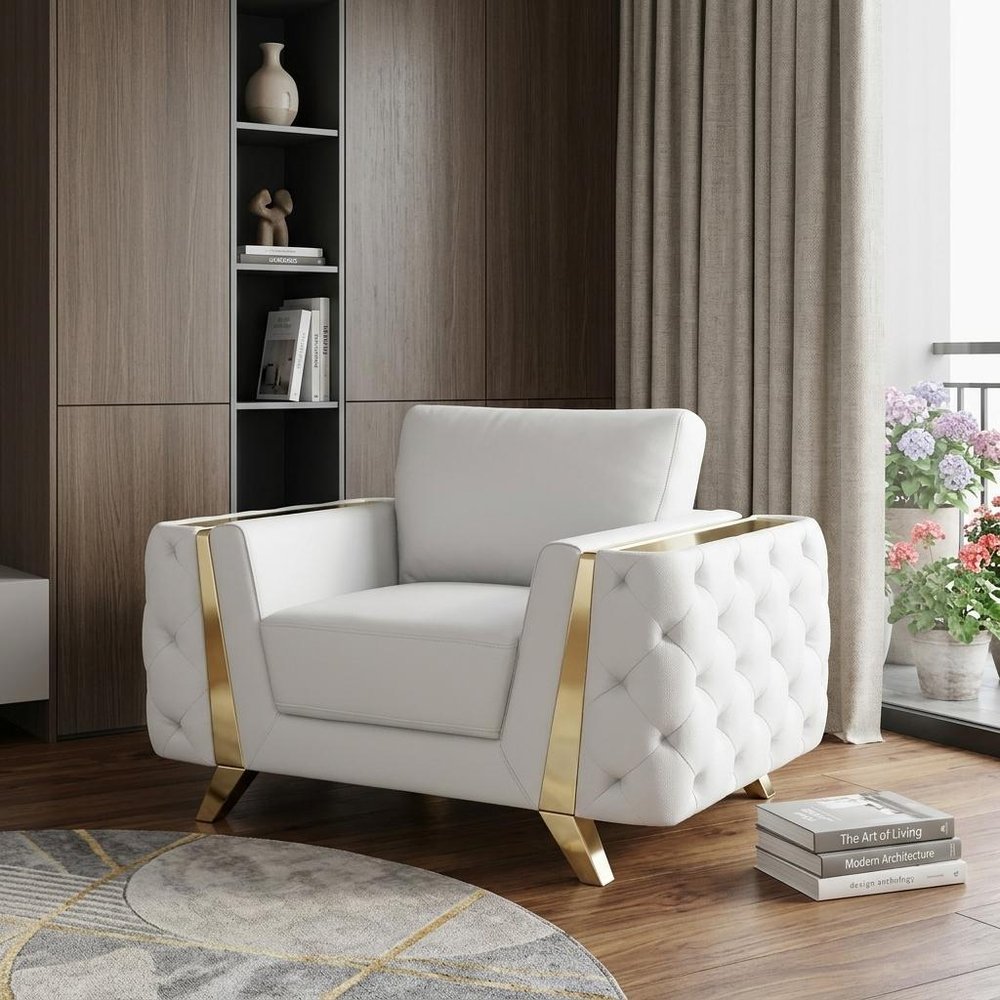 White armchair with gold accents in a modern living room setting