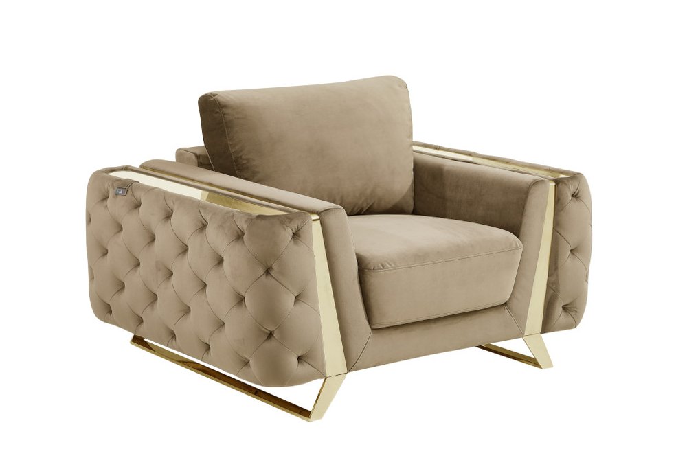 Beige velvet tufted club chair with gold metal accents and legs on a white background.