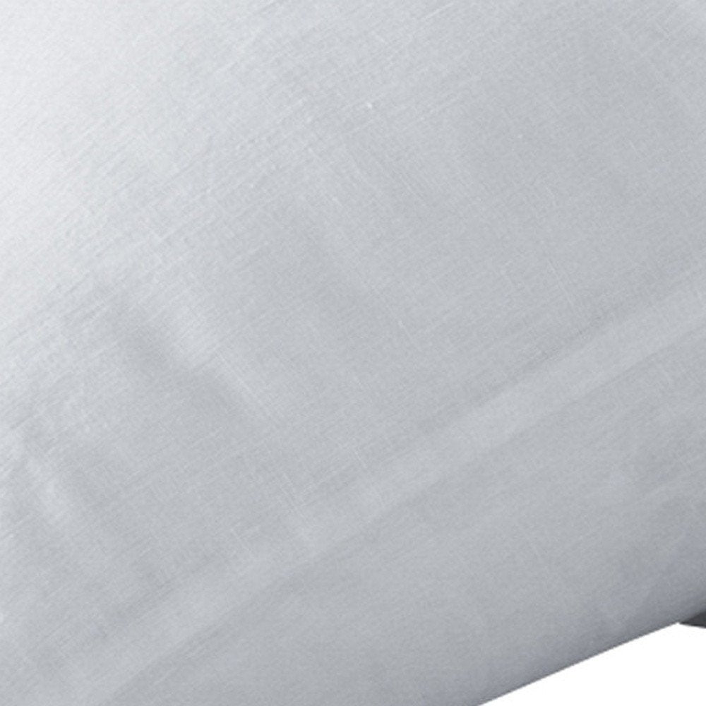 White linen king pillowcases, close-up view of textured fabric.