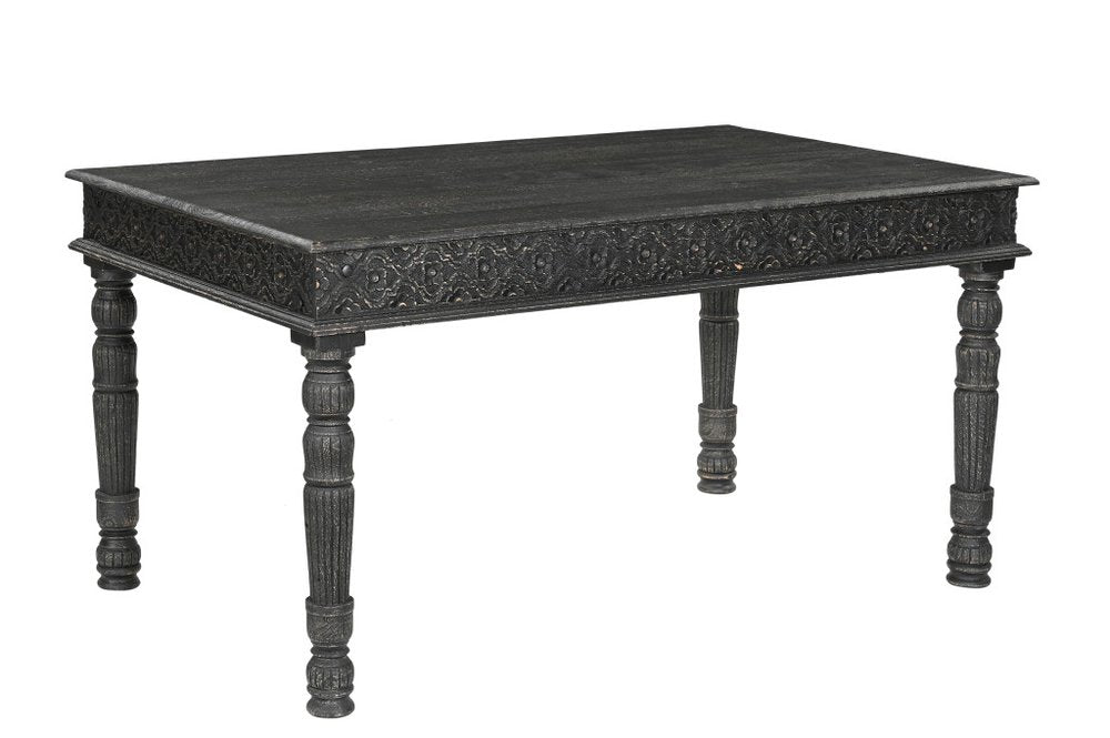 Black solid wood dining table with carved apron and turned legs on a white background.