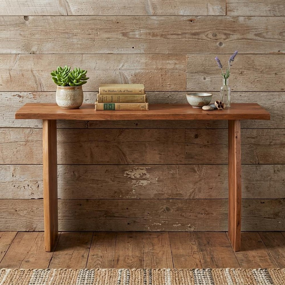 57" Chestnut Solid Wood Sled Console Table. Console table in tan wood.