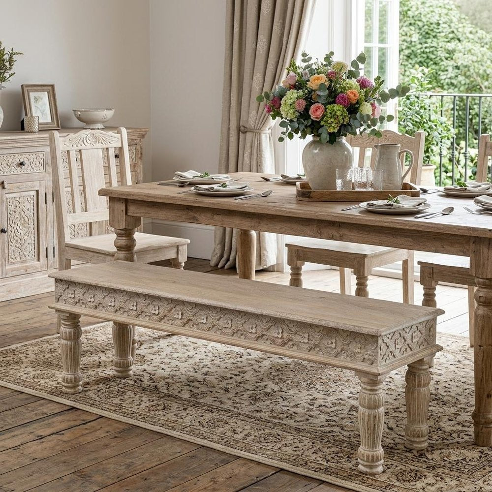 58" White Floral Distressed Solid Wood Dining Bench styled in a furnished interior with a tan wall on a wood floor.