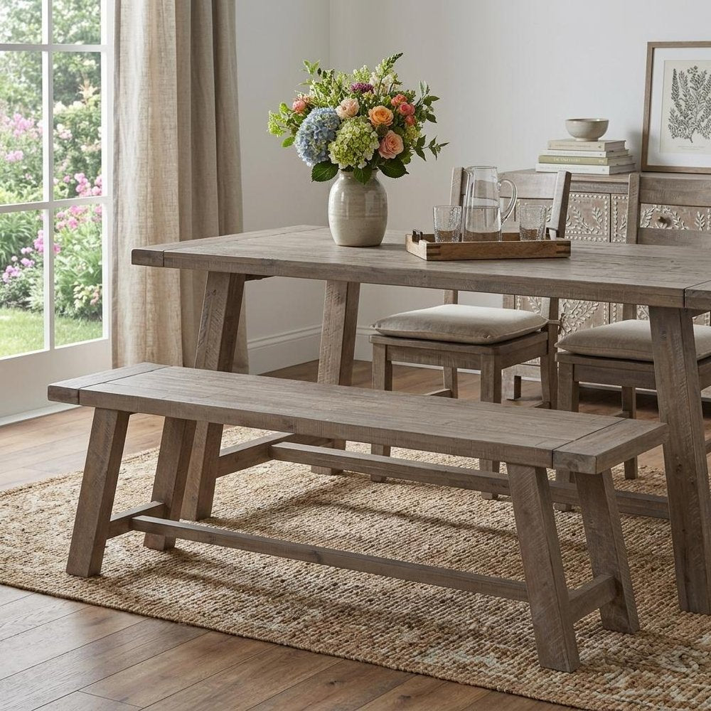 60" Natural Distressed Solid Wood Dining Bench styled in a furnished interior with a light gray wall on a dark wood floor in brown wood.