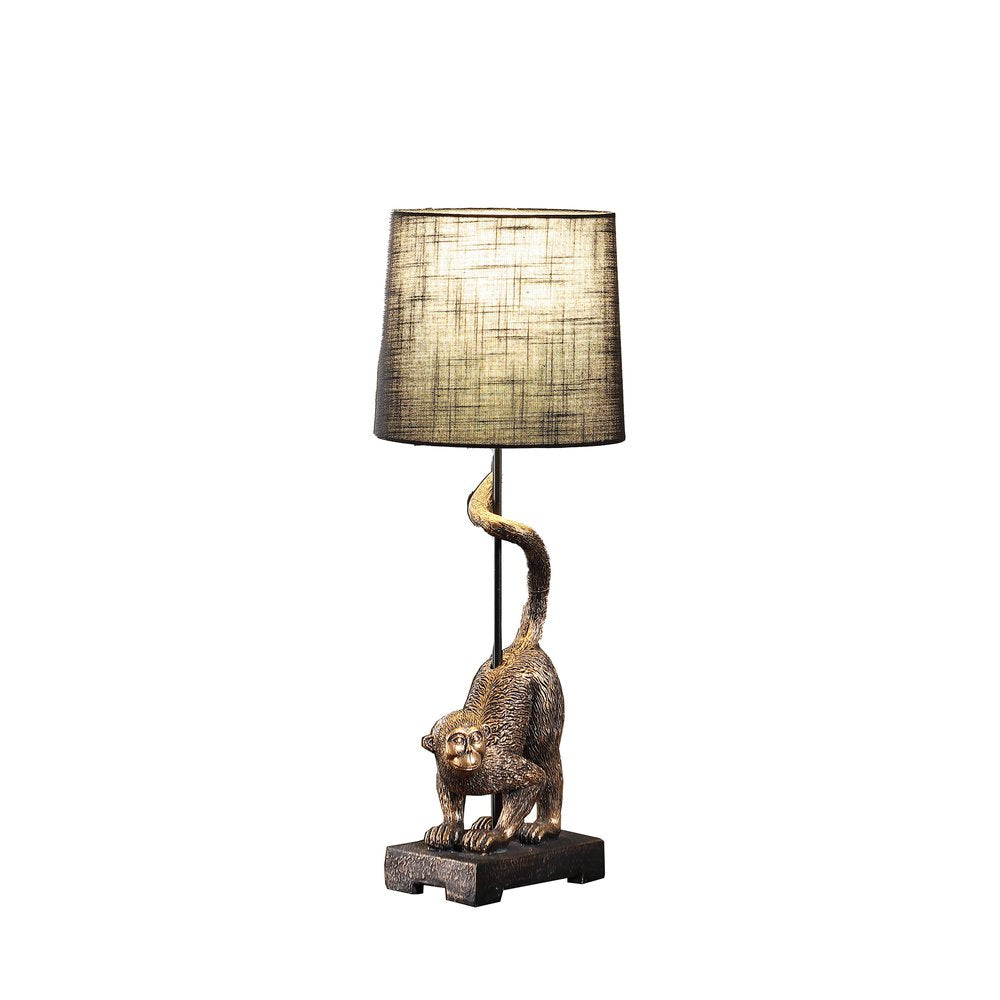 24" Antiqued Gold Monkey Table Lamp With Black Drum Shade. Table lamp isolated on a plain white background, in a gold finish.