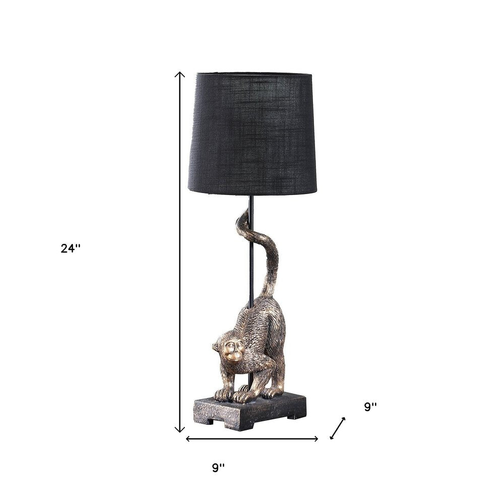 24" Antiqued Gold Monkey Table Lamp With Black Drum Shade. Table lamp isolated on a plain white background, showing its black color.