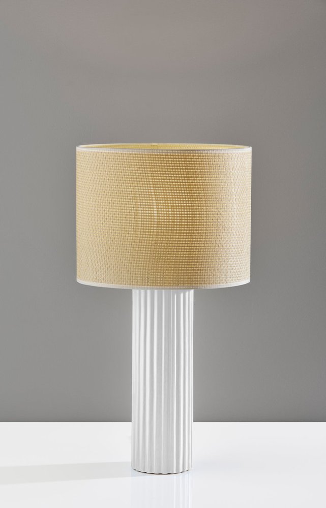 Cropped view of 24" White Ceramic Cylinder Table Lamp With Beige Drum Shade focusing on the beige ceramic surface.
