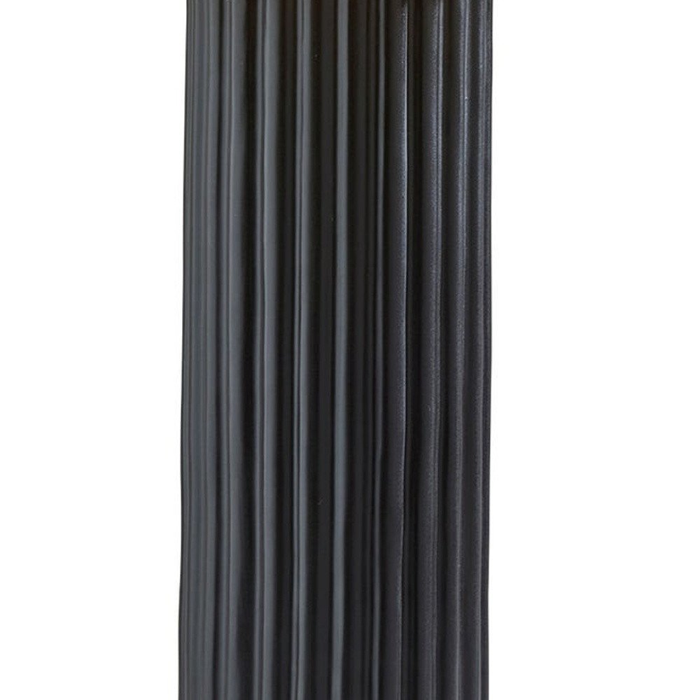 29" Black Ceramic Cylinder Table Lamp With Beige Drum Shade. Table lamp isolated on a plain white background, showing a black ceramic surface.