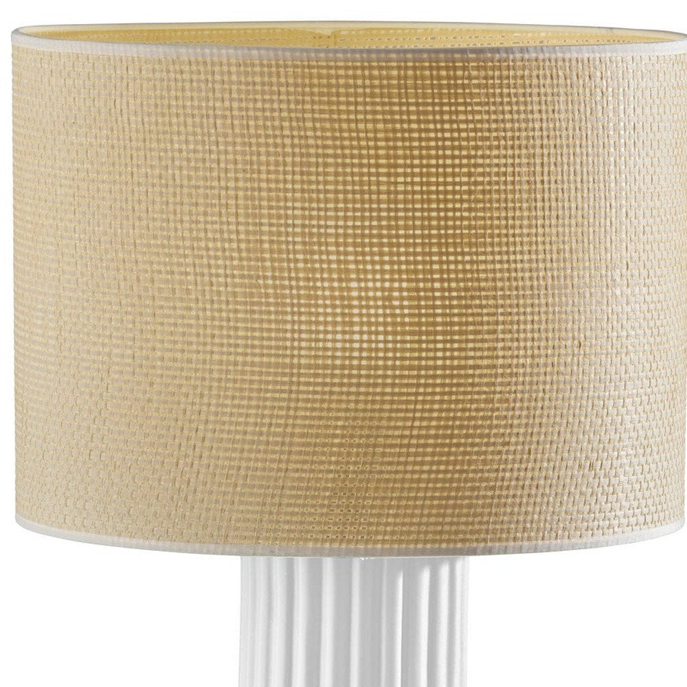 29" White Ceramic Cylinder Table Lamp With Beige Drum Shade. Table lamp isolated on a plain white background, finished in beige ceramic.
