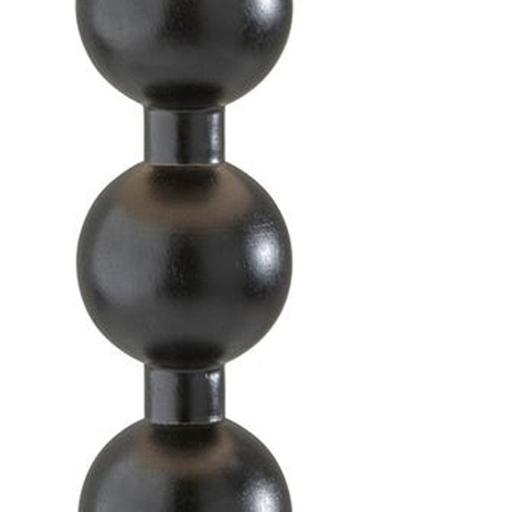 28" Black Solid Wood Candlestick Table Lamp With Off White Drum Shade. Table lamp isolated on a plain white background, showing a black wood surface.