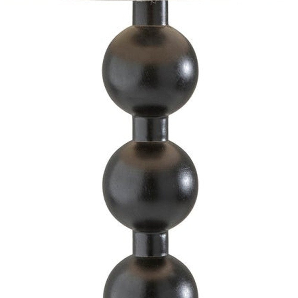 28" Black Solid Wood Candlestick Table Lamp With Off White Drum Shade. Table lamp isolated on a plain white background, finished in black wood.