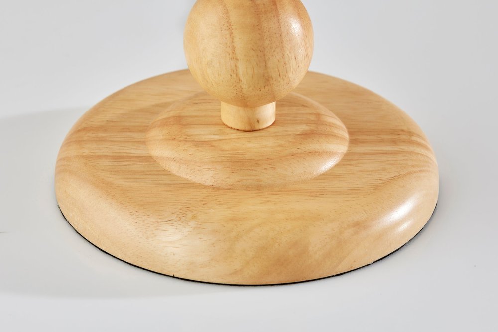 28" Brown Solid Wood Candlestick Table Lamp With Off White Drum Shade. Table lamp isolated on a plain white background, showing a off-white wood surface.