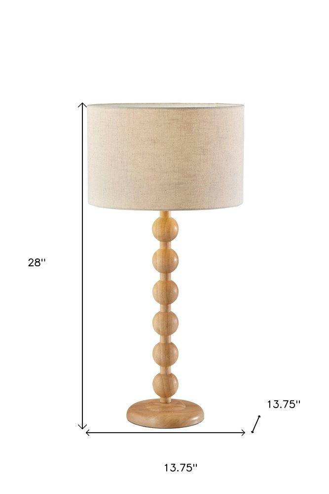 28" Brown Solid Wood Candlestick Table Lamp With Off White Drum Shade. Table lamp isolated on a plain white background, finished in off-white wood.