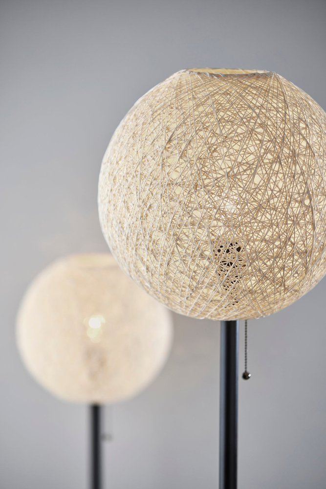 Detail view of 24" Antiqued Bronze Metal Candlestick Table Lamp With Off White Globe Shade, filling the frame with the off-white metal texture.