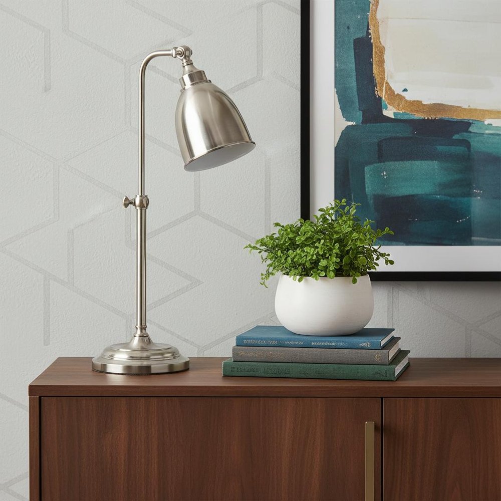 26" Nickel Metal Adjustable Table Lamp With Nickel Dome Shade displayed on a dark wood tabletop in a furnished interior against a light gray wall in silver metal.
