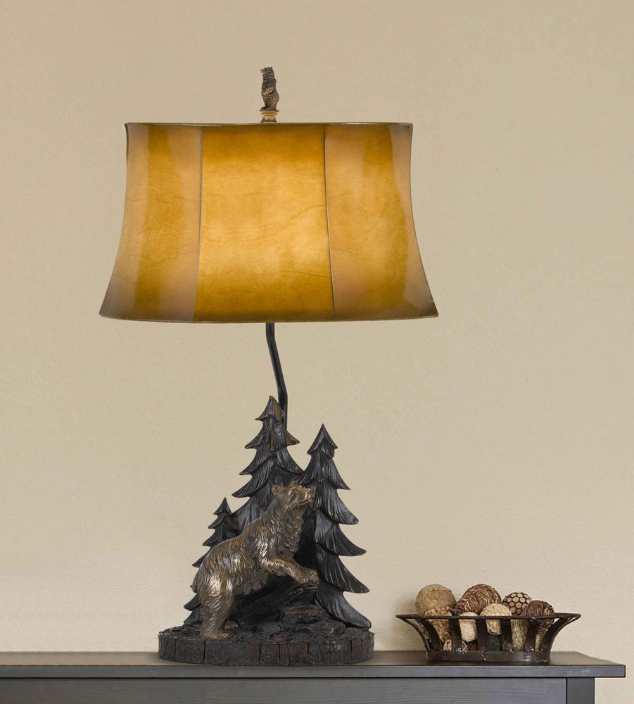 29" Antiqued Bronze Novelty Table Lamp With Brown Bell Shade displayed on a tabletop in a furnished interior against a tan wall.