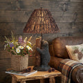 29" Gray Novelty Table Lamp With Brown Empire Shade displayed on a dark wood tabletop in a furnished interior against a dark brown wall.