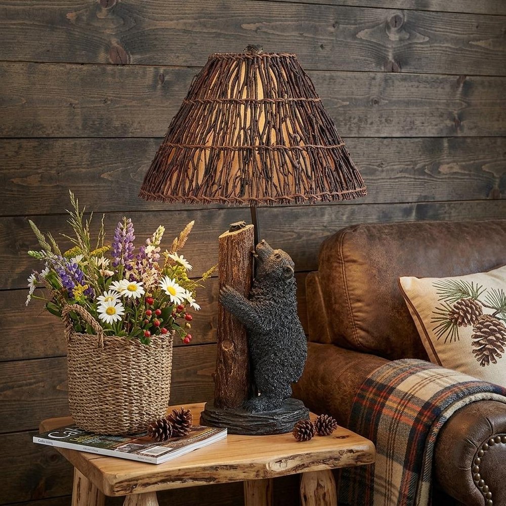 29" Gray Novelty Table Lamp With Brown Empire Shade displayed on a dark wood tabletop in a furnished interior against a dark brown wall.