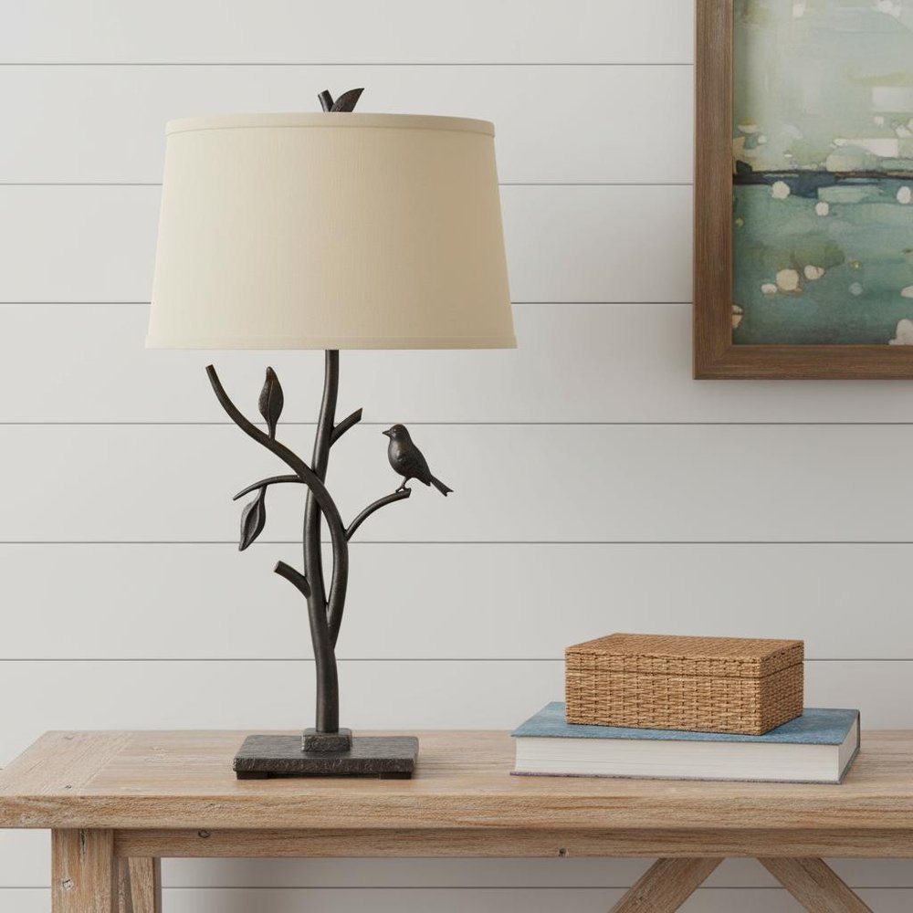 29" Tan Metal Table Lamp With Tan Empire Shade displayed on a wood tabletop in a furnished interior against an off-white wall in light gray metal.