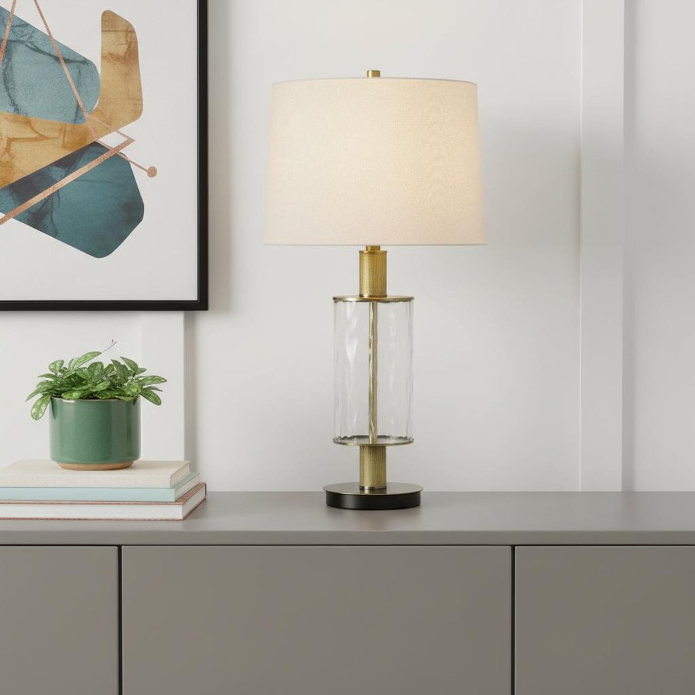 31" Clear Metal Table Lamp With White Empire Shade displayed on a tabletop in a furnished interior against an off-white wall.
