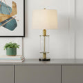 31" Clear Metal Table Lamp With White Empire Shade displayed on a tabletop in a furnished interior against an off-white wall.
