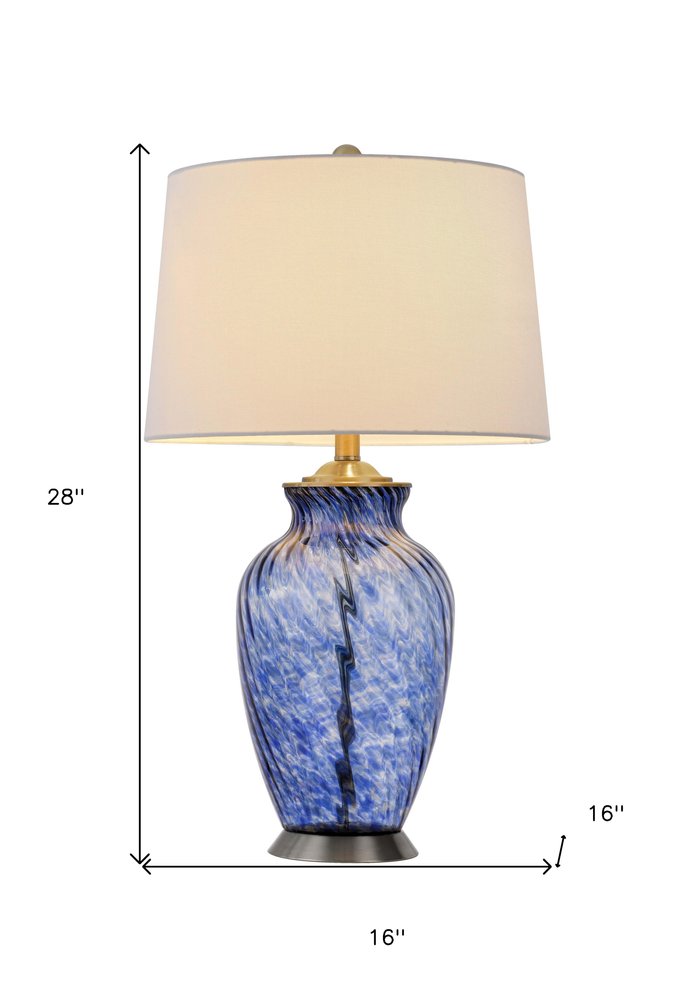 28" Blue Swirl Glass Table Lamp With White Empire Shade. Table lamp isolated on a plain white background, showing a white glass surface.
