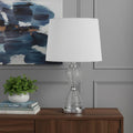 24" Clear Metal Table Lamp With White Empire Shade shown outdoors on an outdoor setting.