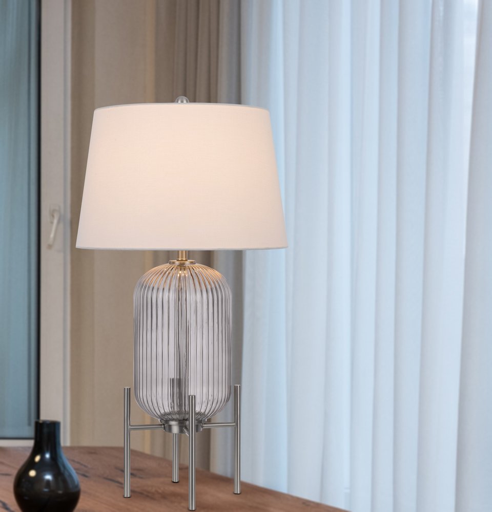 33" Nickel Glass Round Table Lamp With White Empire Shade shown outdoors on an outdoor setting in silver glass.