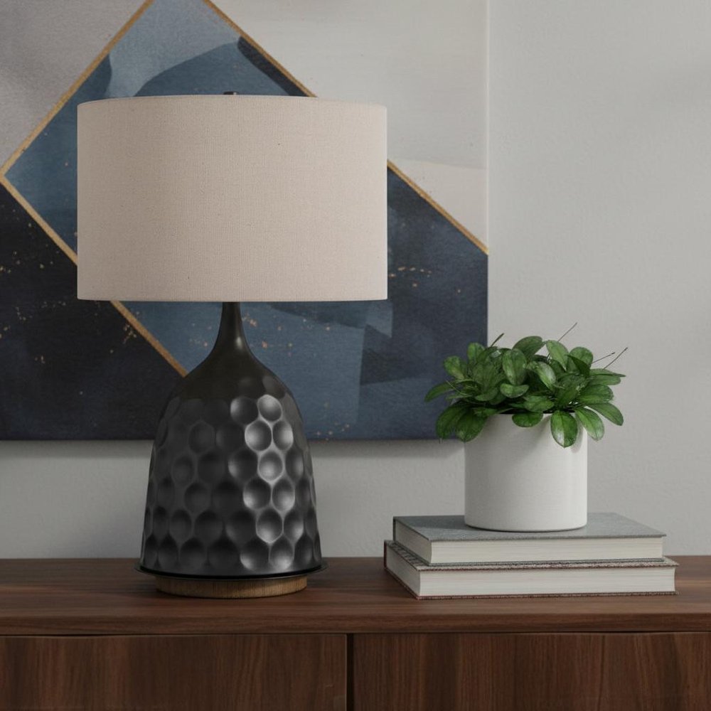 29" Gray Metal Table Lamp With Brown Drum Shade displayed on a dark wood tabletop in a furnished interior against a light gray wall.