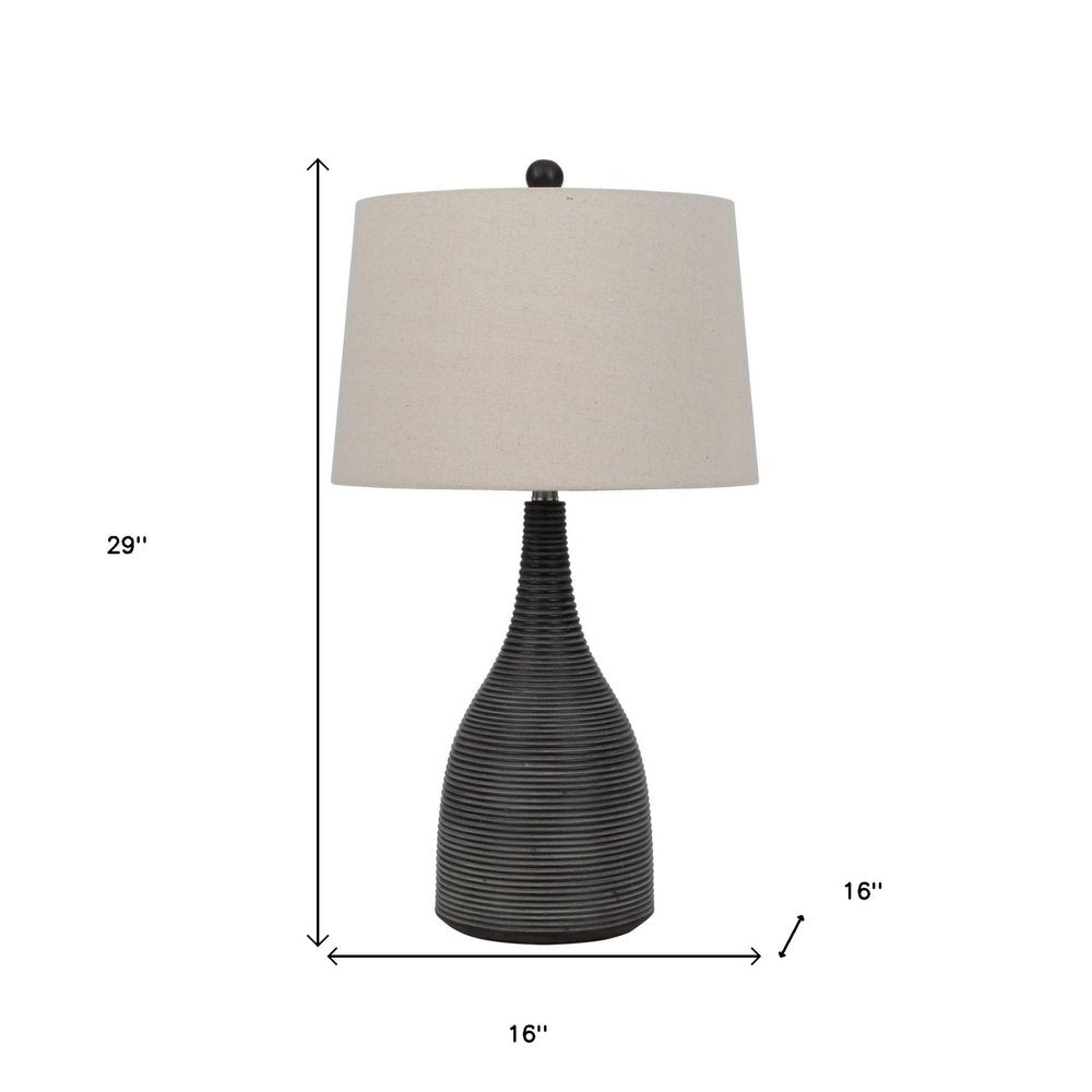 29" Black Ceramic Round Table Lamp With Beige Empire Shade. Table lamp isolated on a plain white background, showing a beige ceramic surface.