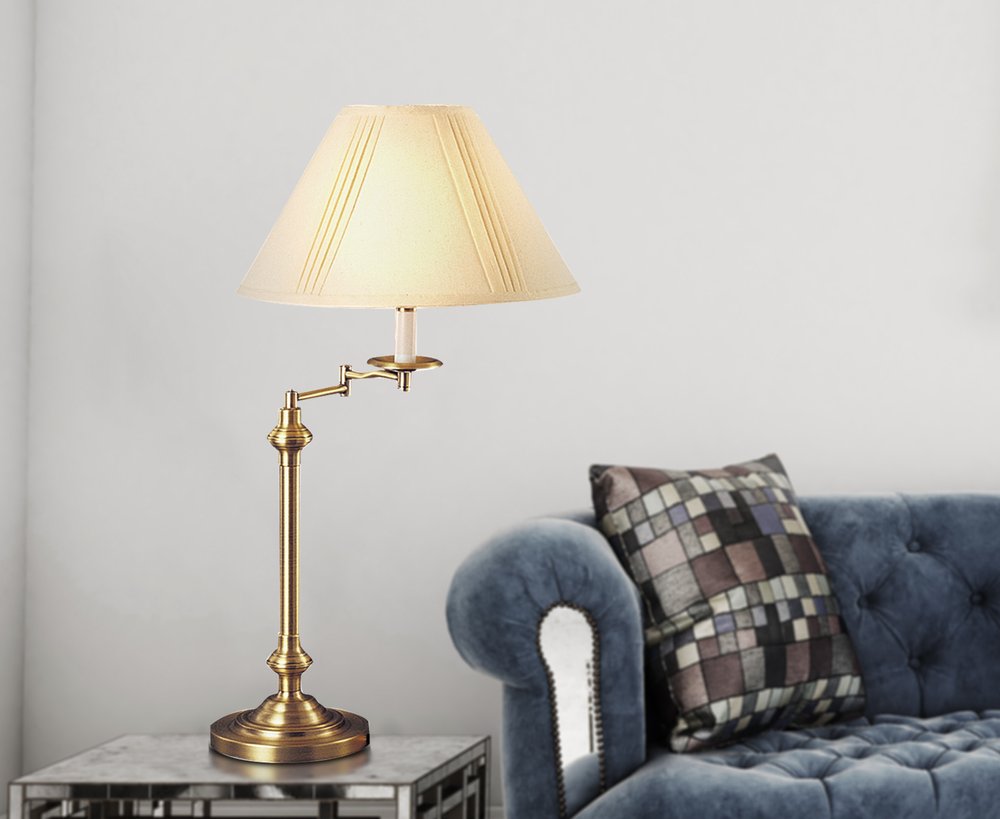 30" Bronze Metal Swing Arm Table Lamp With Off White Empire Shade displayed on a tabletop in a furnished interior against an off-white wall in off-white metal.