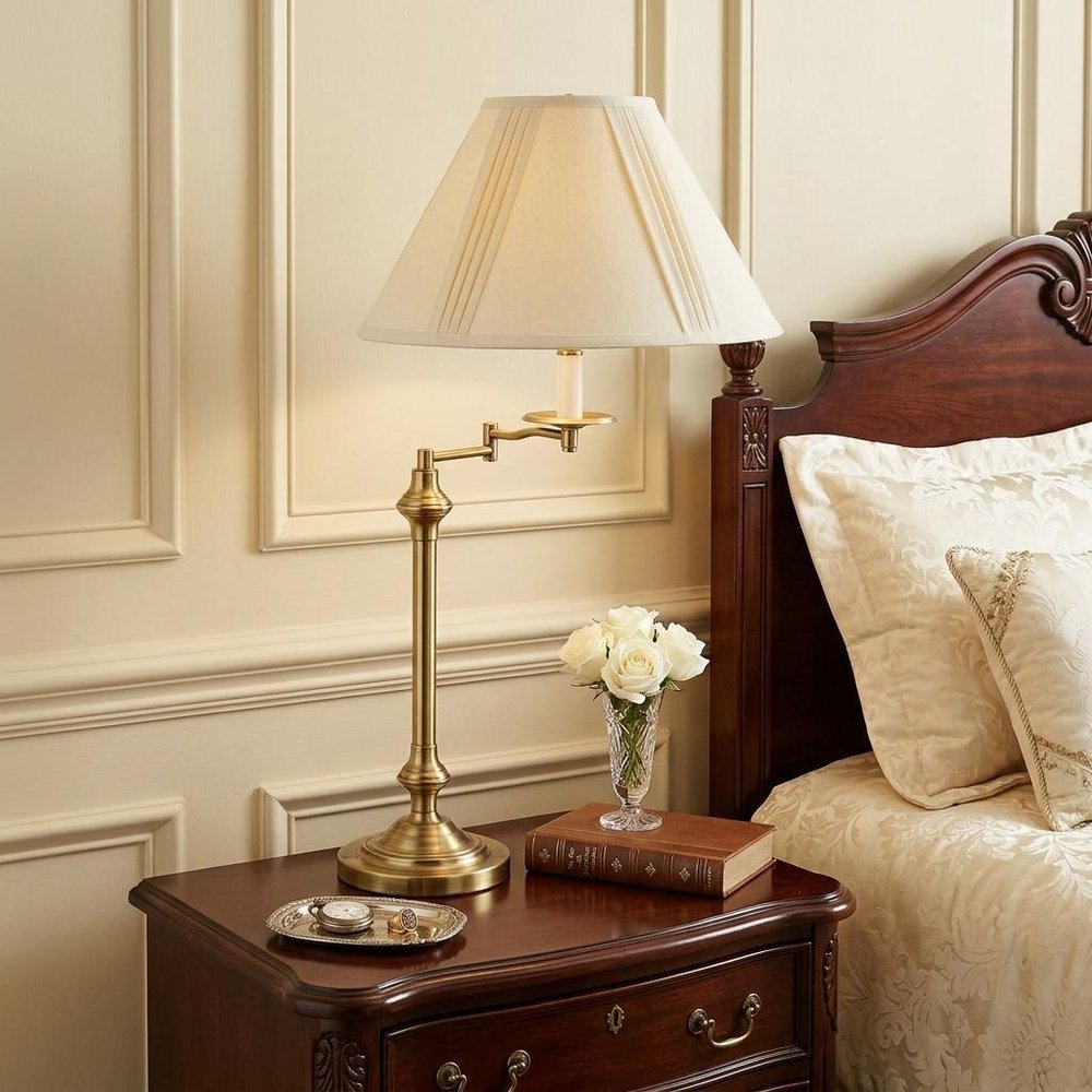 30" Bronze Metal Swing Arm Table Lamp With Off White Empire Shade displayed on a dark wood tabletop in a furnished interior against a cream wall in off-white metal.