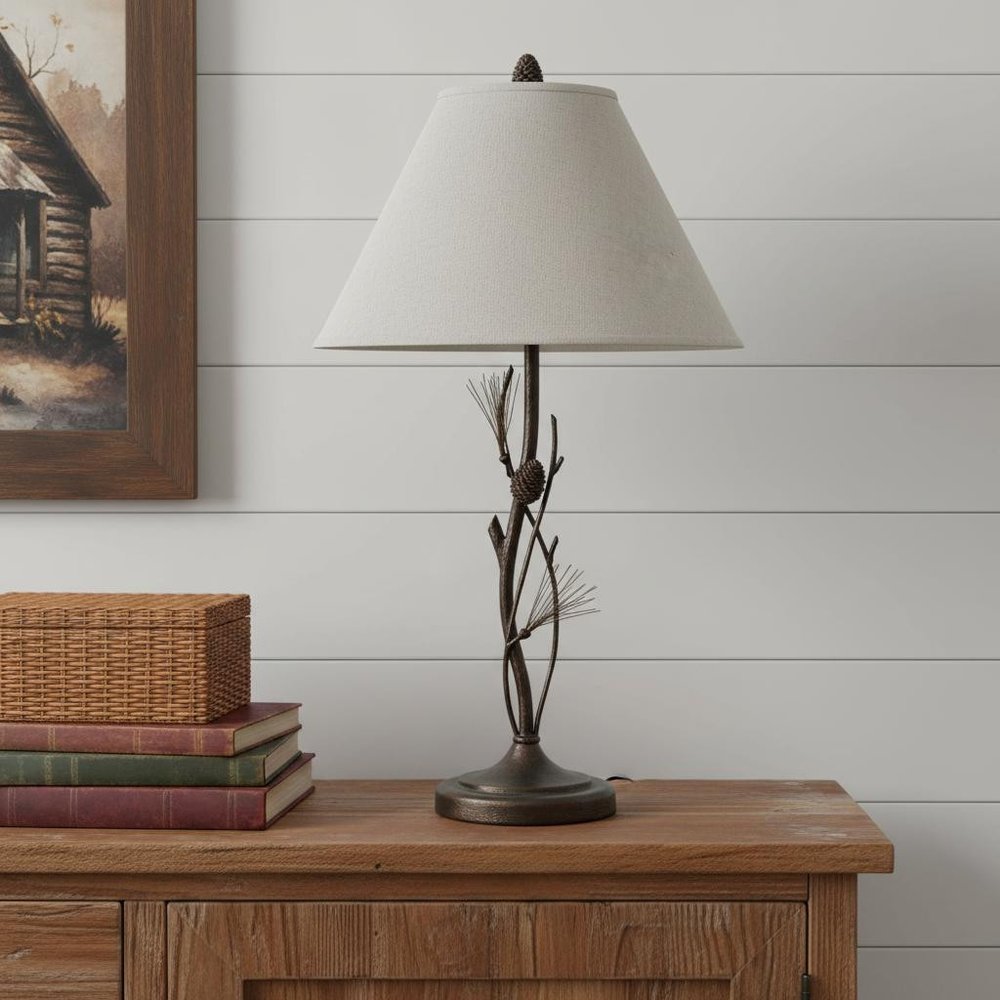 32" Rust Metal Table Lamp With Gray Empire Shade displayed on a dark wood tabletop in a furnished interior against a light gray wall.