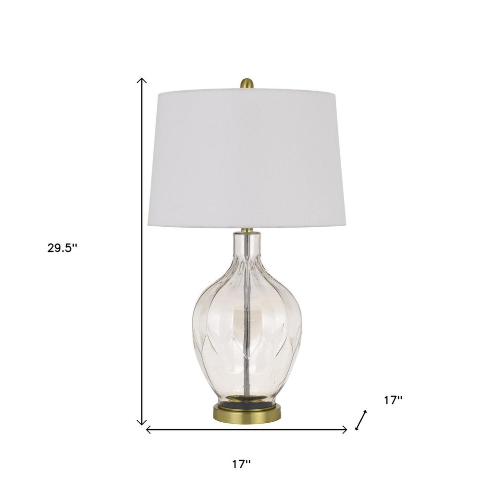 30" Clear Metal Table Lamp With Off White Drum Shade. Table lamp isolated on a plain white background, in a off-white metal finish.