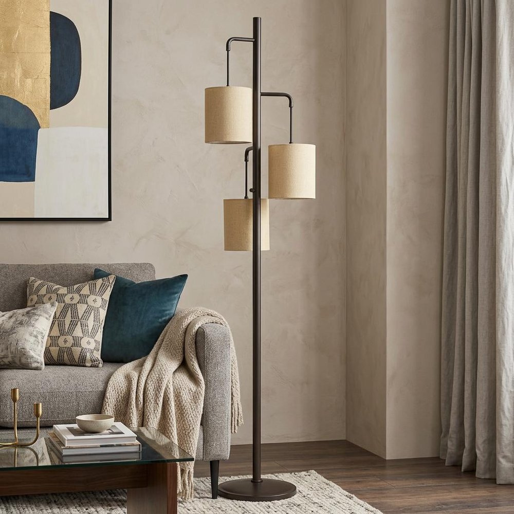 72" Bronze Three Light Traditional Shaped Floor Lamp With Beige Drum Shade in a home interior